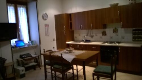 a kitchen with a table and chairs and a kitchen with a sink at Angolo Tranquillo in Siano