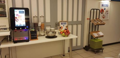a counter in a kitchen with a counter top with a food at Ibis Budget Saint Christol Les Alès in Saint-Christol-lès-Alès