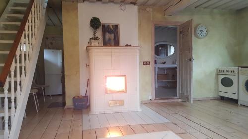 a room with a staircase and a room with a stove at House in the City in Tallinn