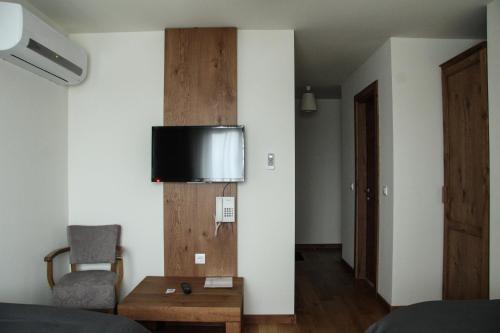 a room with a bed and a chair and a table at B&B Villa Panuka in Pančevo