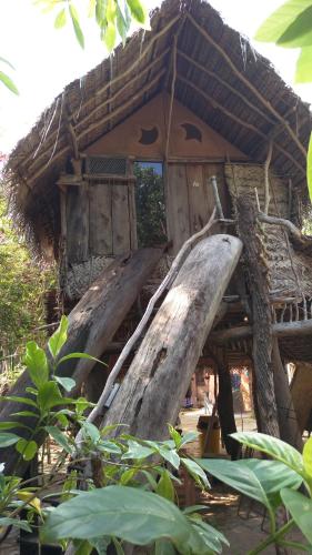 a house with a slide in front of it at Beach Hut in Arugam Bay