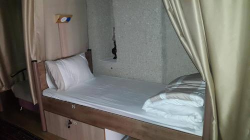 a bunk bed in a room with a mirror at Homestay Cave Hostel in Goreme