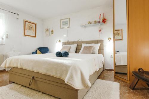 a bedroom with a large bed and a mirror at Bingo Apartment in Split