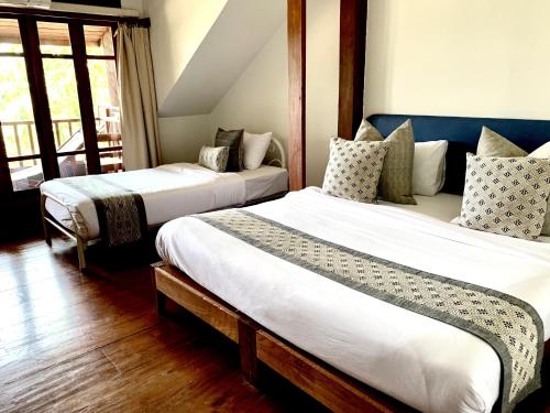 Ένα ή περισσότερα κρεβάτια σε δωμάτιο στο Riverhouse-The Teak House