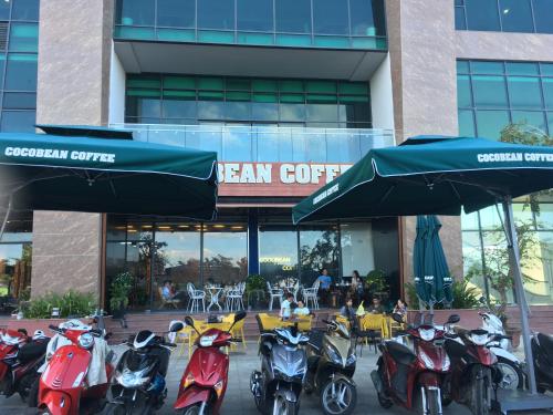 a group of scooters parked in front of a building at Moonlight Bay Hotel & Apartment in Nha Trang