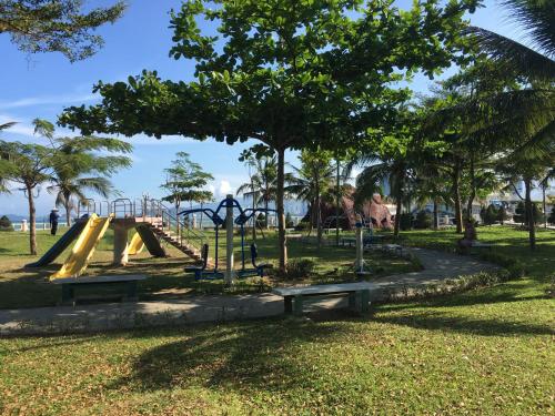 a playground with a slide in a park at Moonlight Bay Hotel & Apartment in Nha Trang