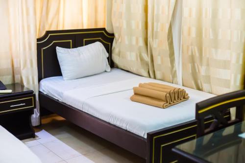 Un ou plusieurs lits dans un hébergement de l'établissement Sleep Inn Hotel - Kariakoo