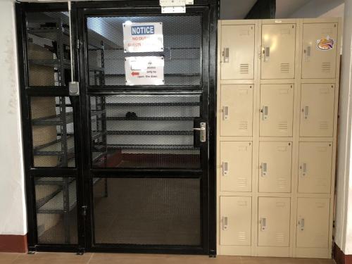 a room with two lockers and a glass door at PLOY Hostel in Bangkok