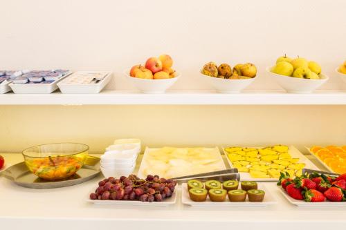 a shelf filled with different types of fruits and vegetables at Hotel Cristina in Los Alcázares