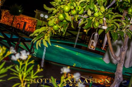 a bunch of bananas hanging from a tree at Achillion Palace in Kalambaki