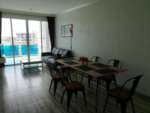 a living room with a table and chairs and a couch at My Resort Hua Hin in Hua Hin