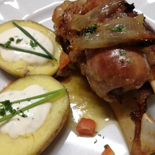 a plate of food with meat and potatoes on it at Hotel Ca' del Bosco in Selva di Cadore