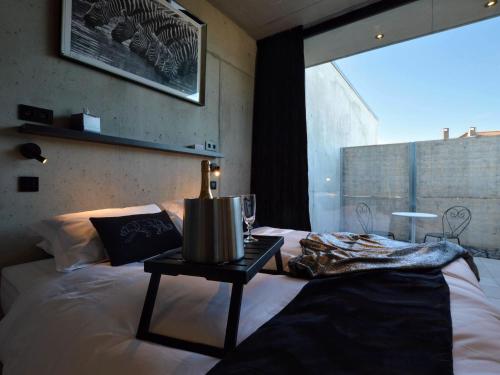 a bedroom with a bed with a table on it at Dalhem Villa with Garden in Dalhem