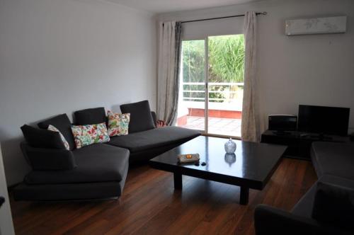 a living room with a couch and a coffee table at Golf El Jadida Appartement in El Jadida