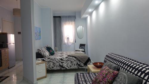 a living room with a bed and a couch at Corte Risco in Ogliastro Cilento