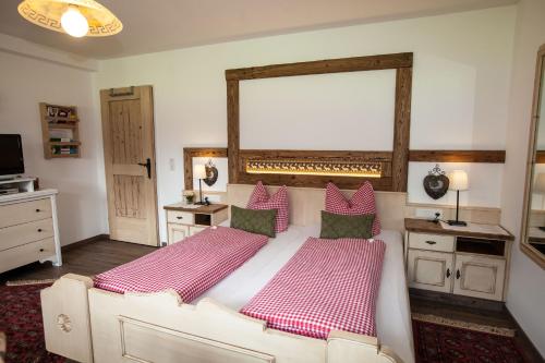 a bedroom with a large bed with red and white sheets at Apart Angela in Mayrhofen