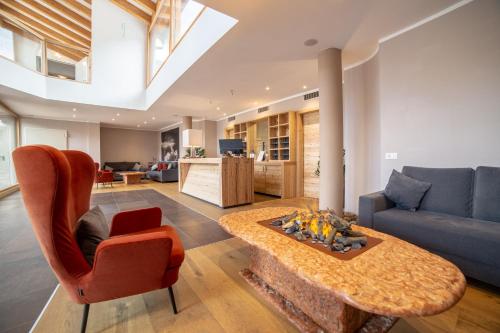 a living room with a couch and a coffee table at Caminetto Mountain Resort in Lavarone