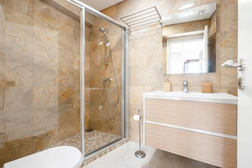 a bathroom with a shower and a sink at Loft 1º de Maio in Tavira