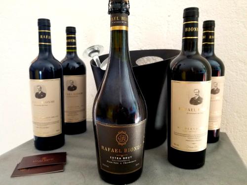 a group of four bottles of wine on a counter at Apart Hotel Beira do Mar in Florianópolis