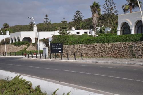 a street with a sign in front of a building at Royal Golf Appartement Deluxe in El Jadida