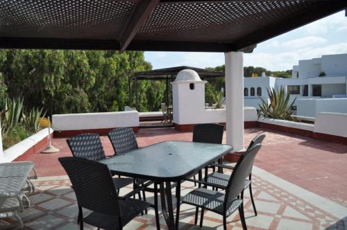 a black table and chairs on a patio at Royal Golf Appartement Deluxe in El Jadida