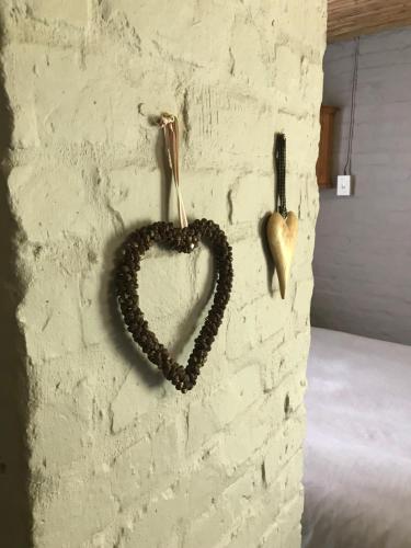 a heart hanging on a brick wall at A Piece of Life in Bredasdorp
