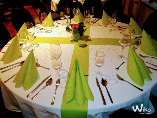 a table with wine glasses and napkins on it at Ambiente in Soltau