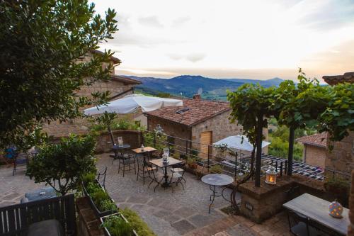 a patio with tables and umbrellas in a building at Misia Resort in Orvieto