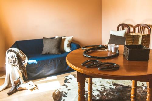 a living room with a blue couch and a table at Camping Fort Bravo in Tabernas