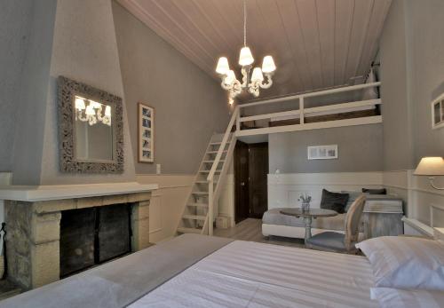 a bedroom with a bed and a loft bed with a fireplace at Boutique Hotel Skamnos Arachova in Arachova