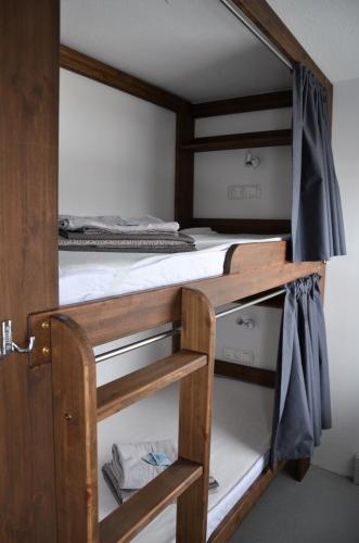 a bunk bed in a room with two beds at Loft Family Hotel in Imatra