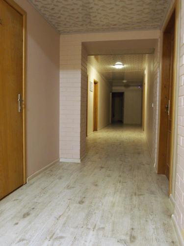 an empty hallway in an office building with wood floors at Hostelis Laurita in Kaunas