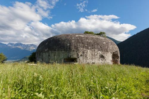 an old building sitting in a field of grass at Garni Marianne in Malles Venosta