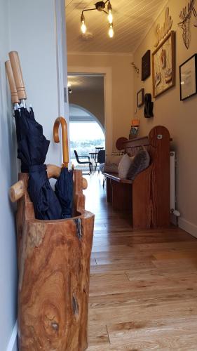 a living room with an umbrella in a wooden container at Airanloch, Loch Ness, Adult Only in Lochend