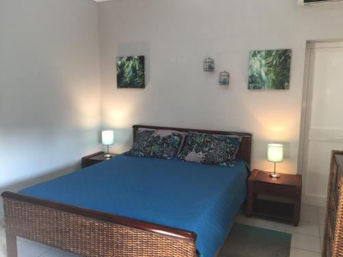 a bedroom with a bed with blue sheets and two lamps at Agua Viva in Albufeira