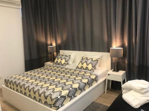 a bedroom with a large white bed with pillows at Apartment Aspalathos Centar in Split