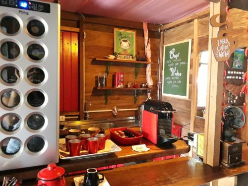a kitchen with a counter with pots and pans at Pousada Alfa e Ômega in Alto Paraíso de Goiás