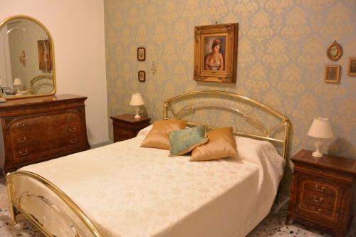 1 dormitorio con 1 cama con 2 mesitas de noche y espejo en B&B Piazza Madonnina, en Battipaglia