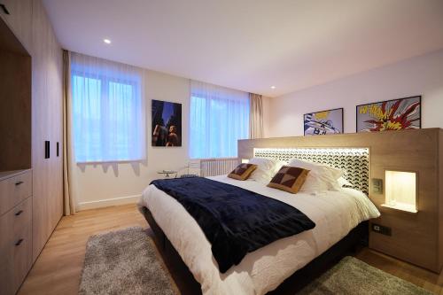 um quarto com uma cama grande e uma janela grande em B&B Suites 124 em Bruxelas