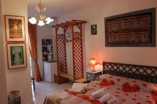 una camera da letto con un letto con fiori rossi di B&B Su Nuraghe a SantʼAntìoco