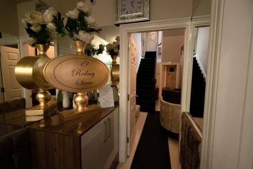 a dressing room with a flower arrangement on a counter at 19 Rodney Street Apartments in Liverpool