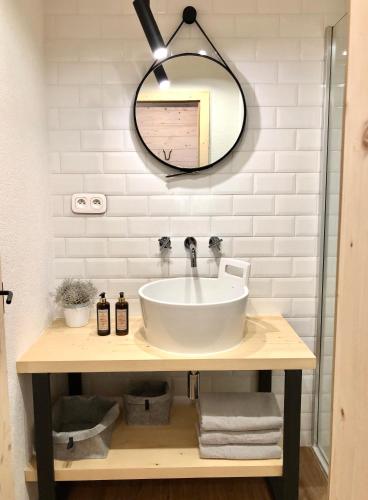 a bathroom with a sink and a mirror at NORDIK 1496 in Vysoké Tatry