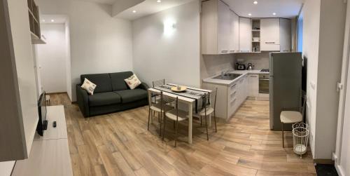 a kitchen and living room with a couch and a table at Ca du Sergio - Il Mesco in Levanto