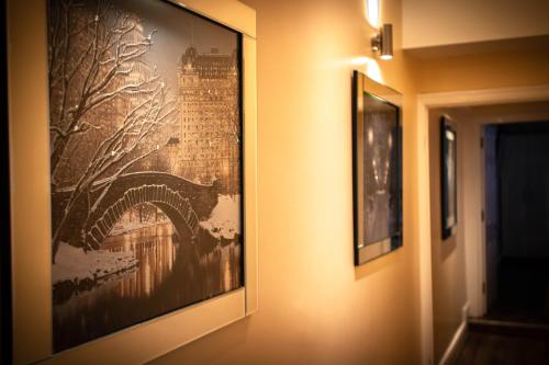 a hallway with two framed pictures on the wall at 19 Rodney Street Apartments in Liverpool