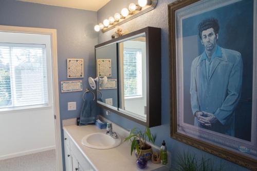 a bathroom with a picture of a man in a suit at My Big Art Project in Santa Rosa