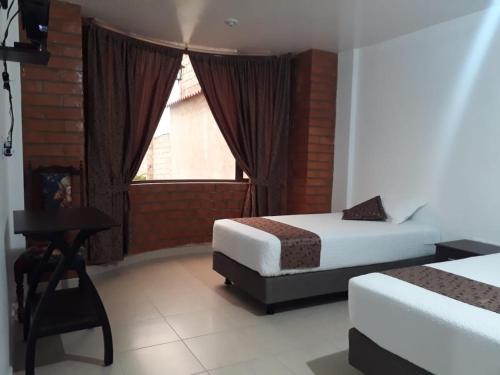 Llit o llits en una habitació de Hotel Kampak Wasi