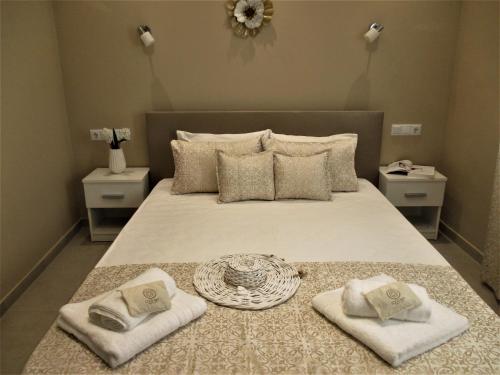 a bedroom with a bed with two towels on it at Jolen House in Skala Kallirachis