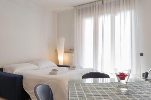 a hotel room with a bed and a glass of wine on a table at Appartamento Verona Fiera e Centro in Verona