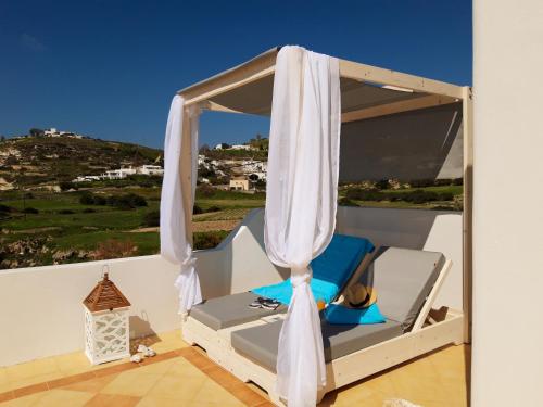 a room with a bed and a window with a view at Psilandis Studios in Adamas