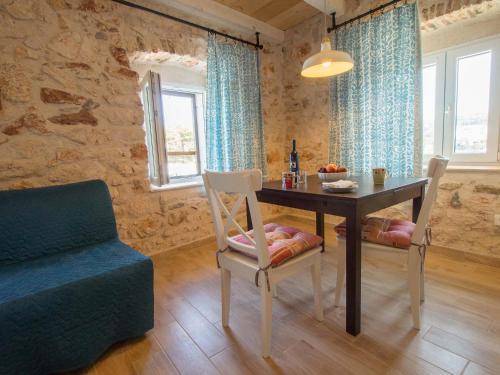 a living room with a table and a chair and a couch at House at the seafront in Stari Grad